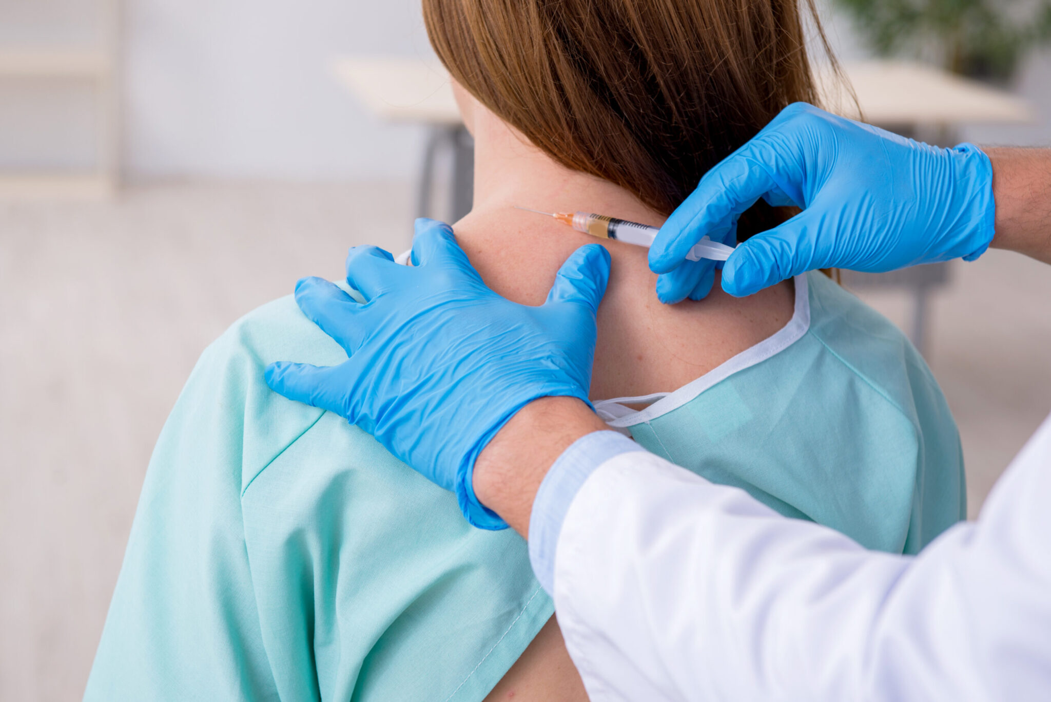 patient recieving an injection by gloved provider